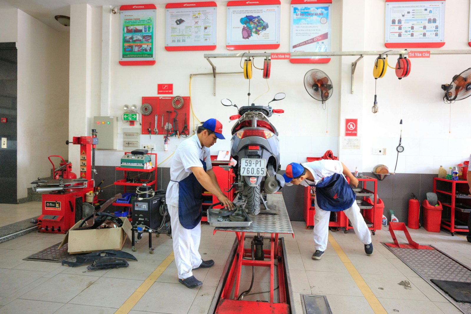 A scooter being serviced in a dedicated two-wheeler bay.